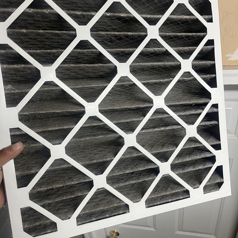 HVAC air filter heavily clogged with dust and debris HVAC air filter heavily clogged with dust and debris