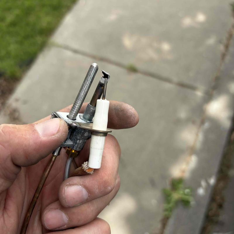 Thermocouple assembly held in technician’s hand outdoors Thermocouple assembly held in technician’s hand outdoors