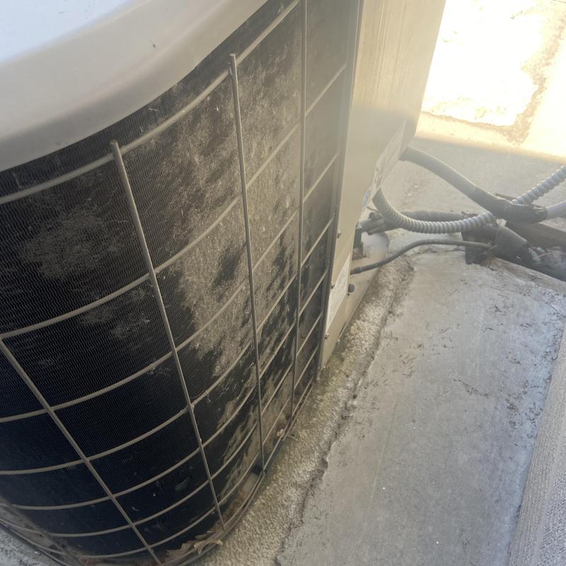 Condenser coil with dirt buildup and wiring connections Condenser coil with dirt buildup and wiring connections
