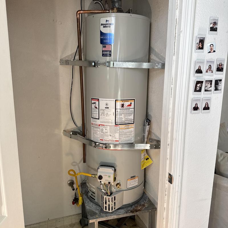 Water heater with new supply lines installed in closet