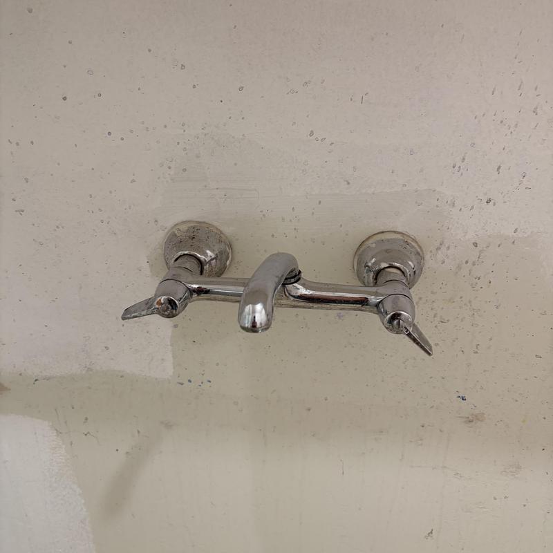 Wall-mounted faucet with two valve handles