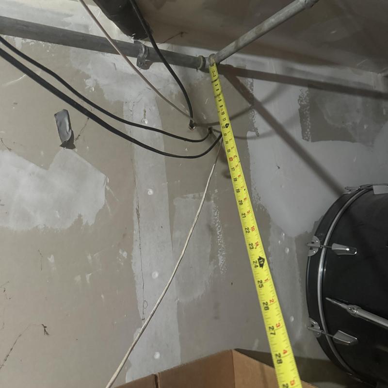 Laundry drain wall opening with measuring tape