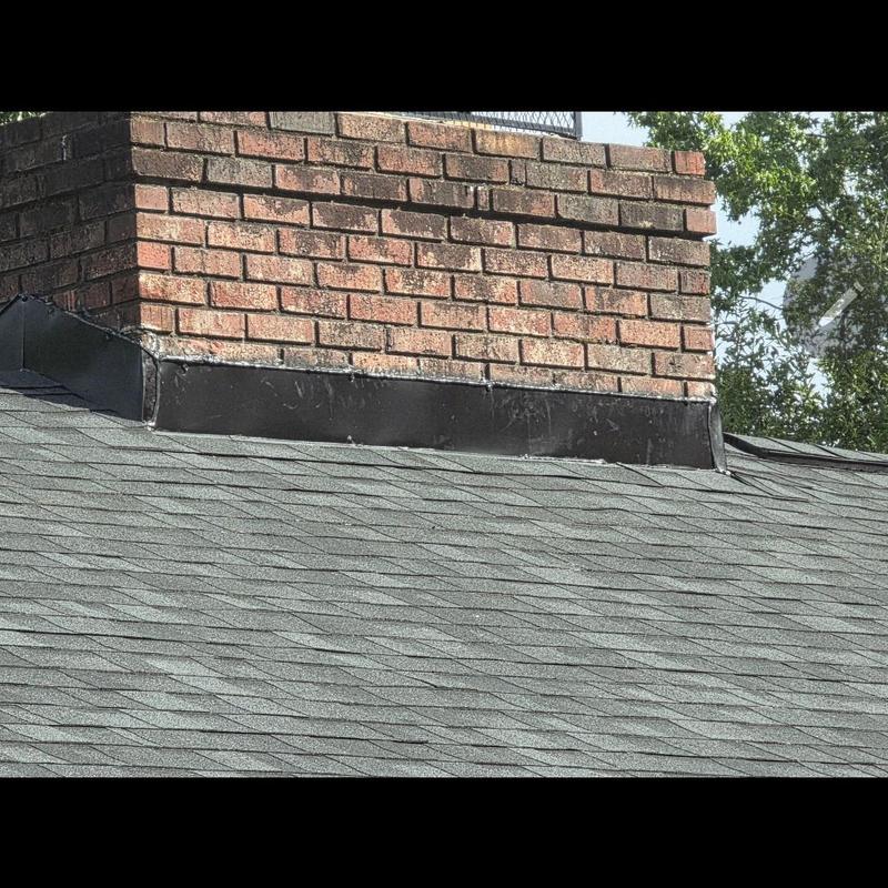 Chimney roof flashing on asphalt shingle roof