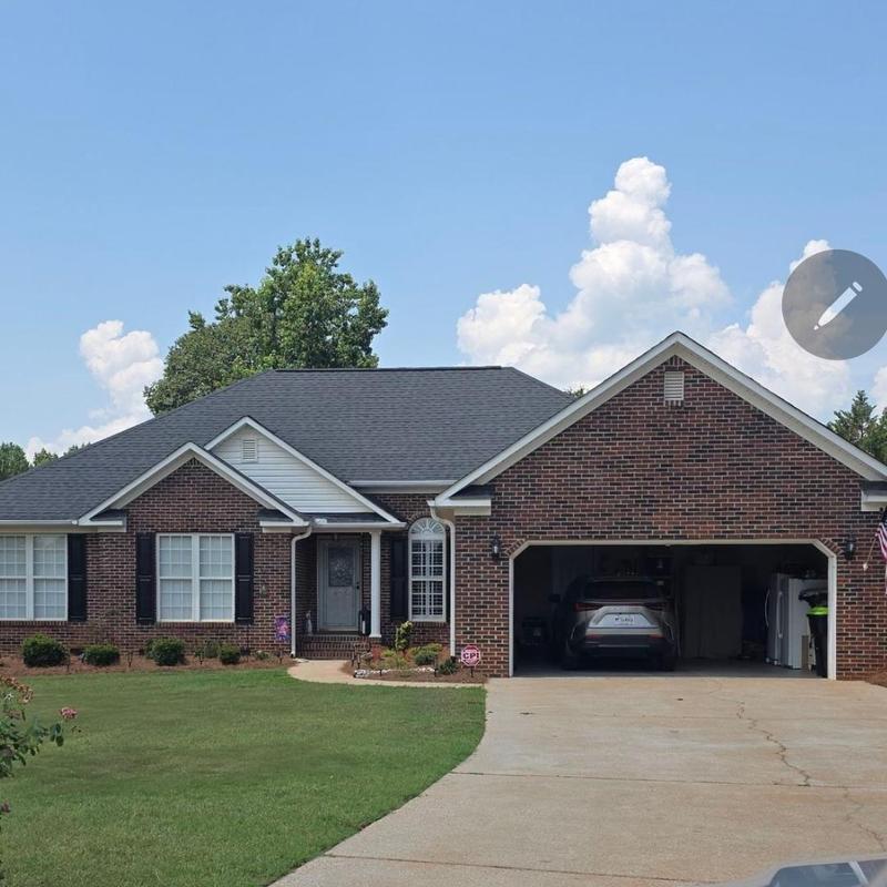 Ridge shingles with metal installation on brick home