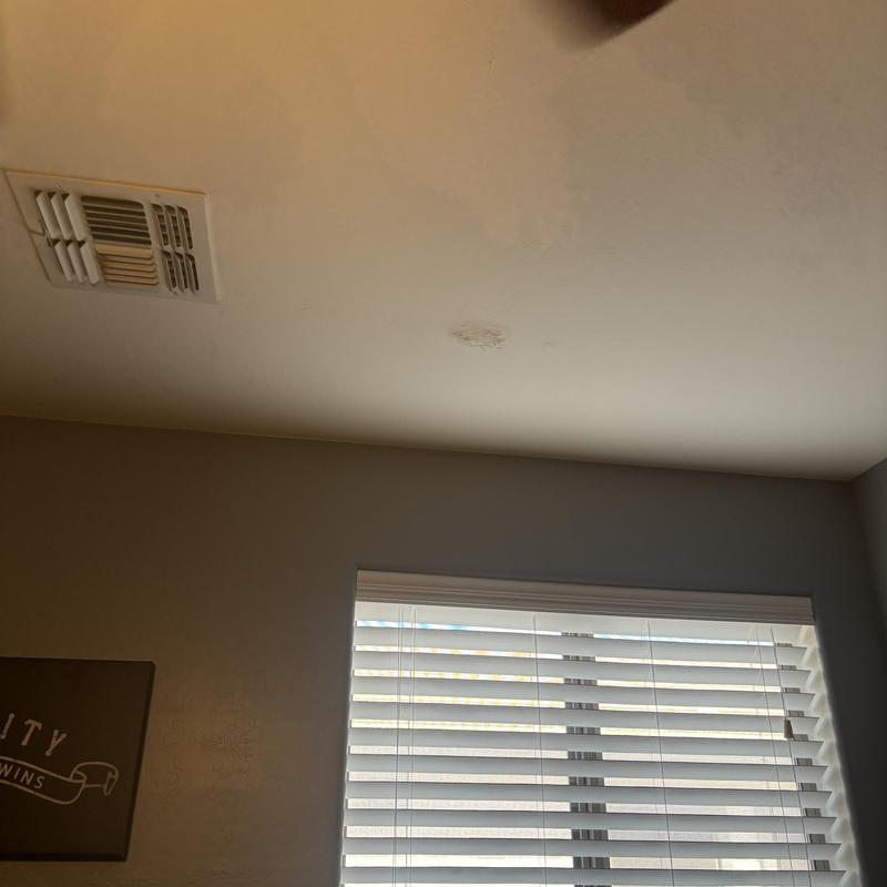 Ventilation vent in ceiling near window blinds