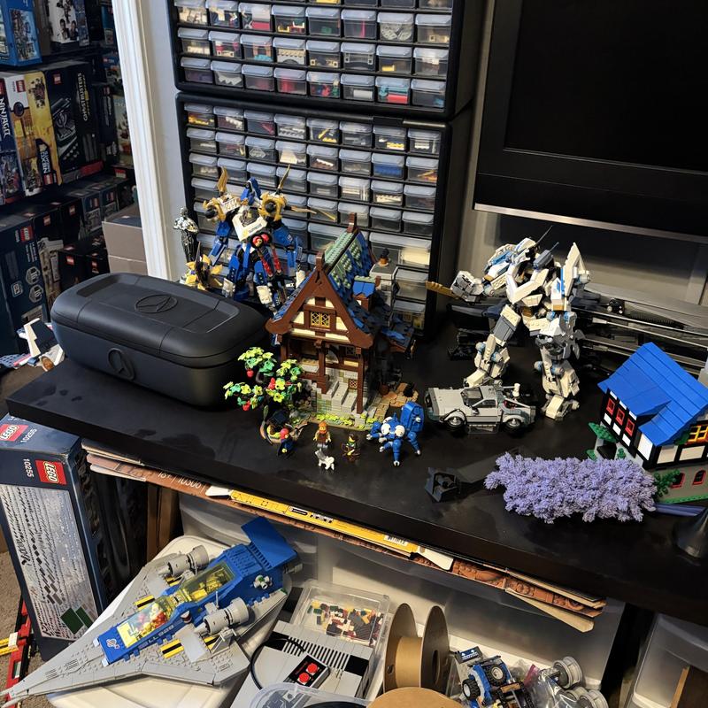 Lego display with mechs, house, and spaceship models