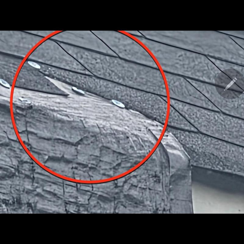 Roof shingles with missing pieces and exposed wood beam