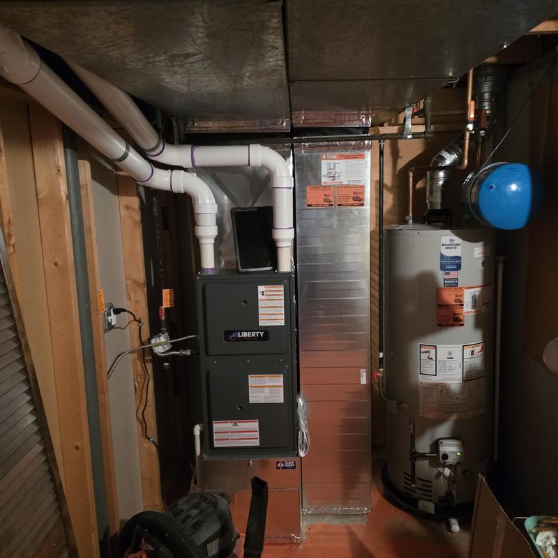 Liberty furnace with PVC vent pipes in basement