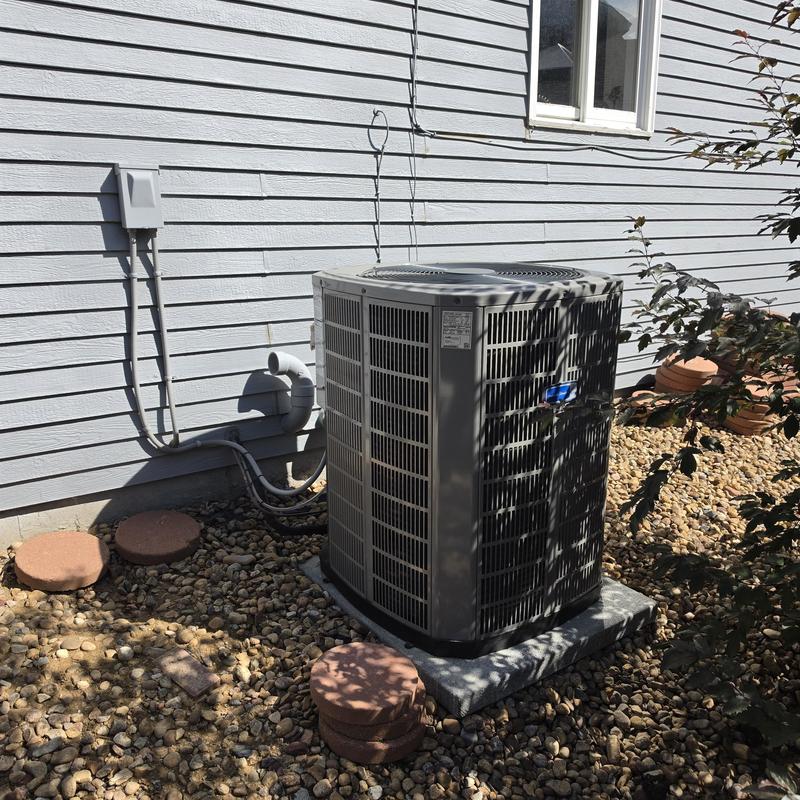 American Standard air conditioner unit outdoors near house