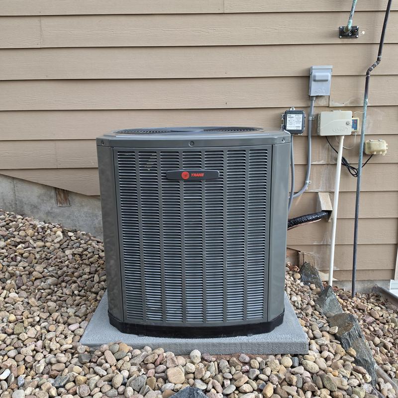 Trane XR13 air conditioner unit on concrete pad