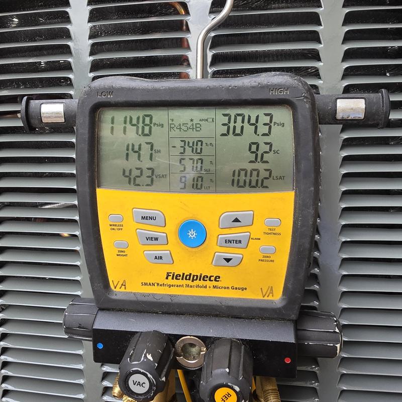 Refrigerant manifold gauge on Trane air conditioner unit