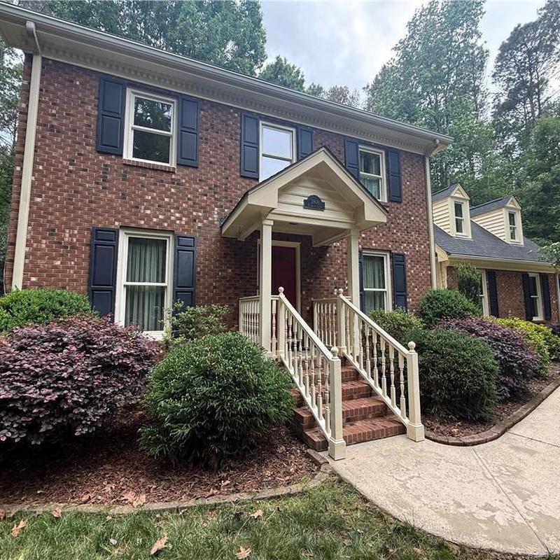 Brick siding and porch railing with fresh curb appeal