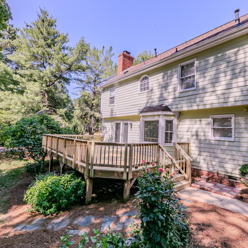 Wooden backyard deck with railing and steps Wooden backyard deck with railing and steps