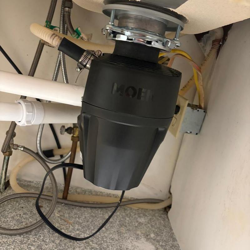 Garbage disposal installation with repiped drain system Garbage disposal installation with repiped drain system