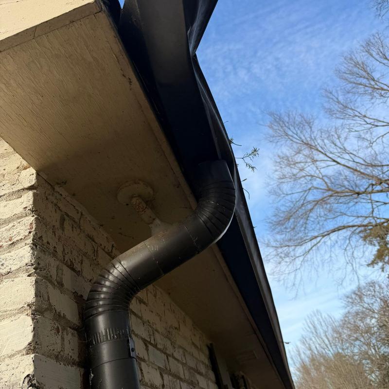 Downspout and gutter system on brick house exterior