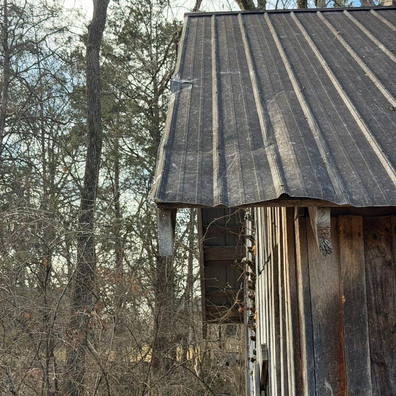 Metal roofing panel with bent and weathered edges