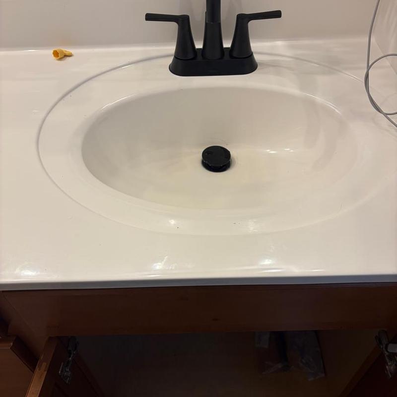 Bathroom sink with black faucet and drain stopper Bathroom sink with black faucet and drain stopper