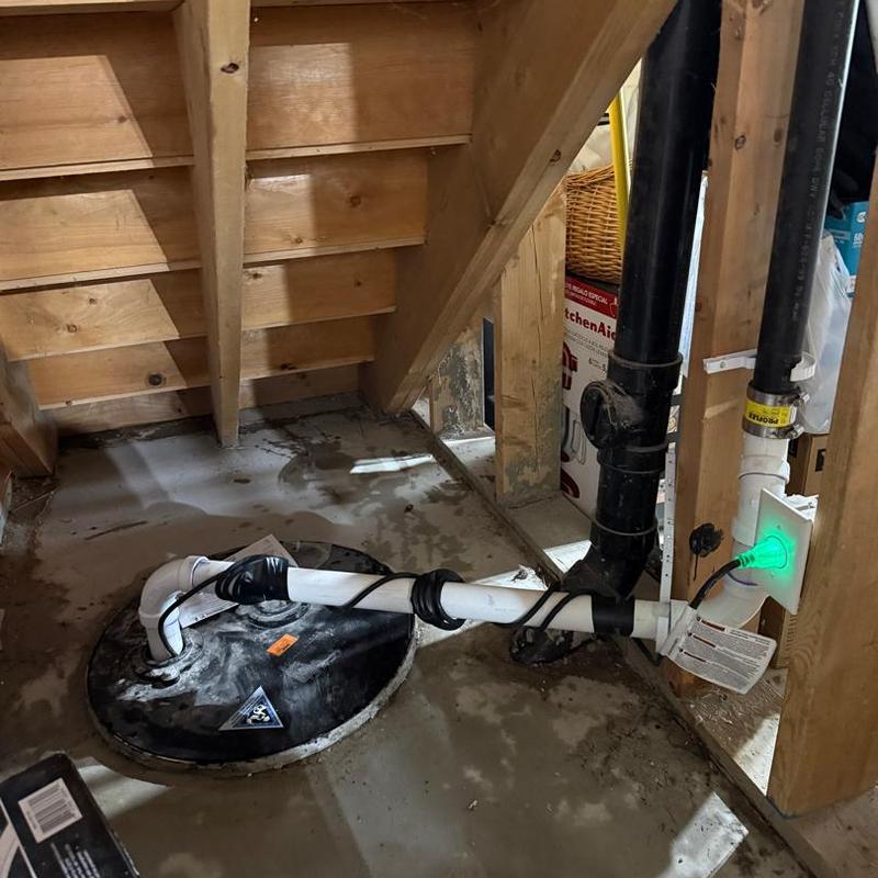 Sump pump system with new wiring in basement corner Sump pump system with new wiring in basement corner