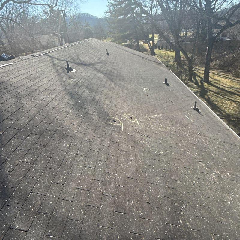 Shingle roof with hail damage and marking spots