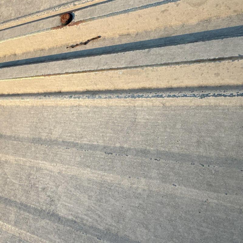 Commercial roof surface showing hail damage and wear