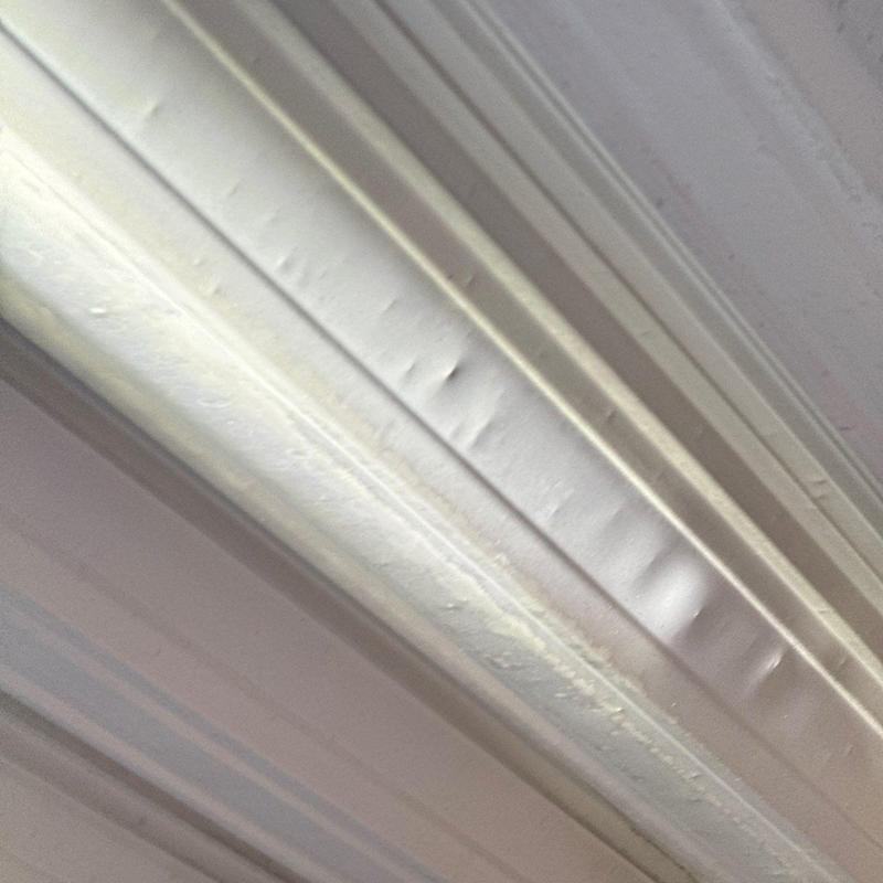 Metal roof panel showing hail damage dents