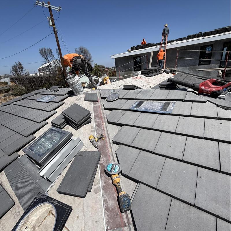 Flat tile roof with skylights under installation Flat tile roof with skylights under installation