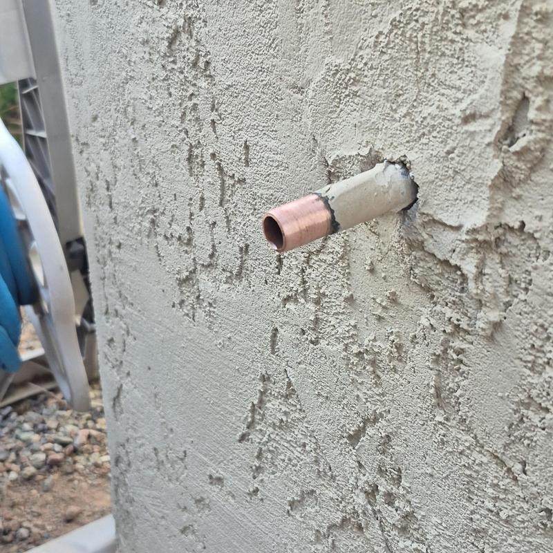 Copper pipe for outdoor hose bib installation on stucco wall