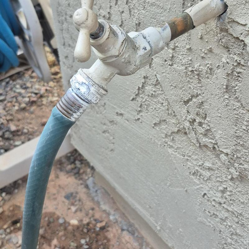 Outdoor hose bib with attached garden hose