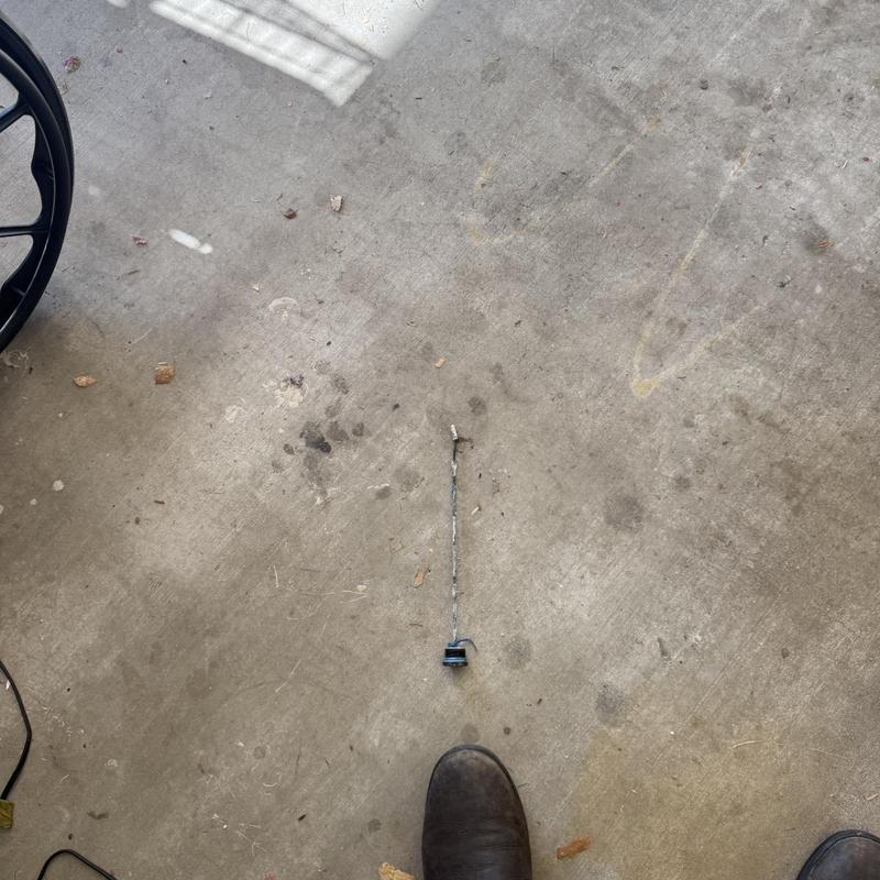 Water heater anode rod removed on concrete floor