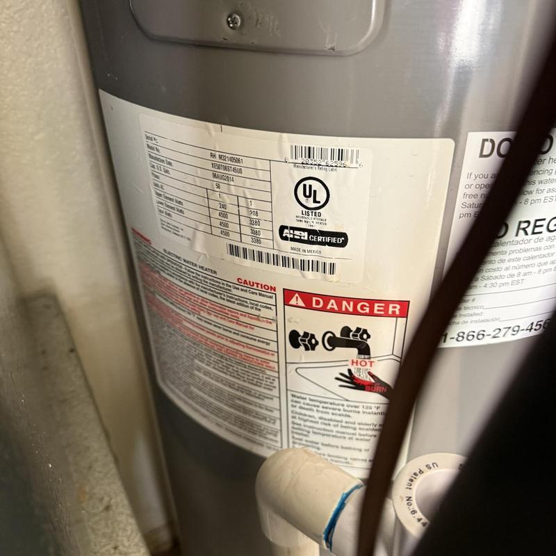 Water heater tank with warning and specification labels