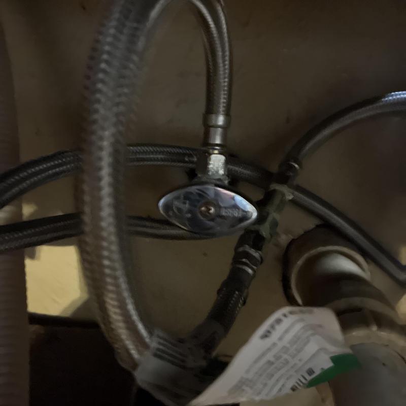 Angle stop valve and braided supply lines under sink Angle stop valve and braided supply lines under sink