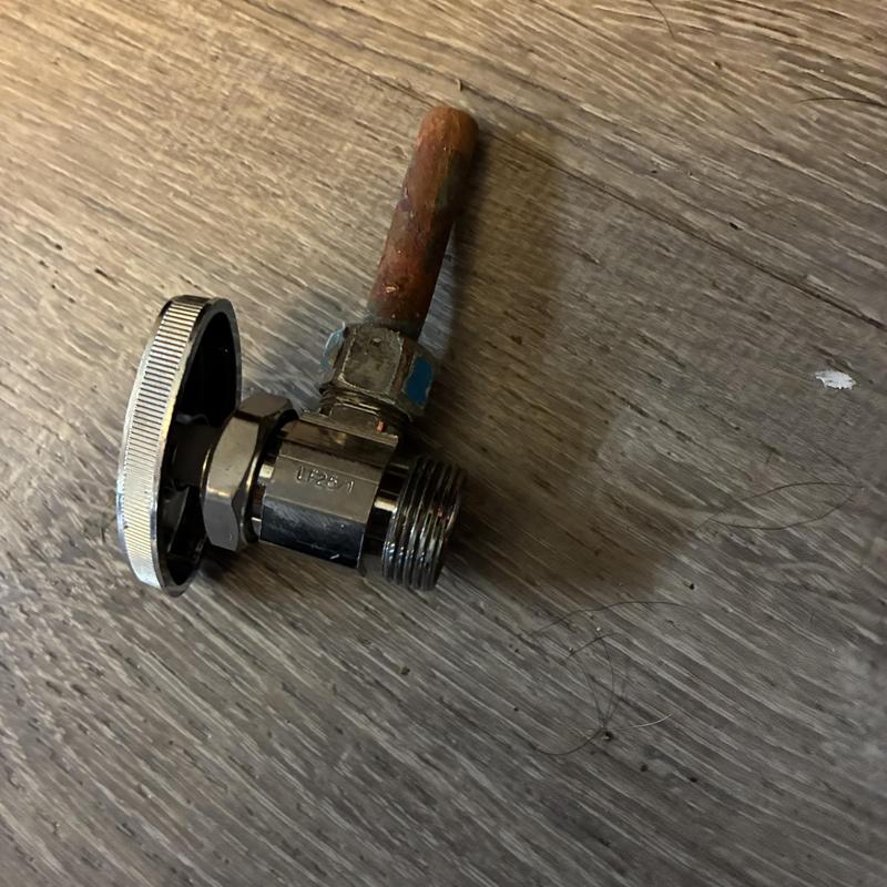 Angle stop valve with rusted copper pipe on wood floor Angle stop valve with rusted copper pipe on wood floor