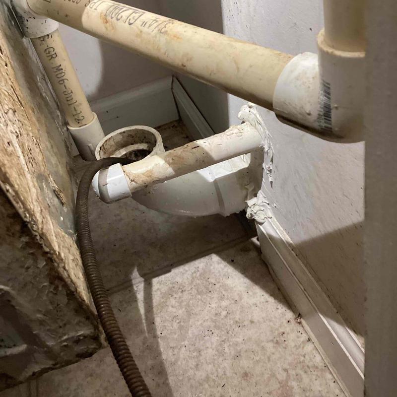 PVC drain pipe with clogged algae removal tool inserted PVC drain pipe with clogged algae removal tool inserted