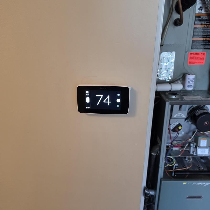 Sensi 2 thermostat installed on wall near furnace
