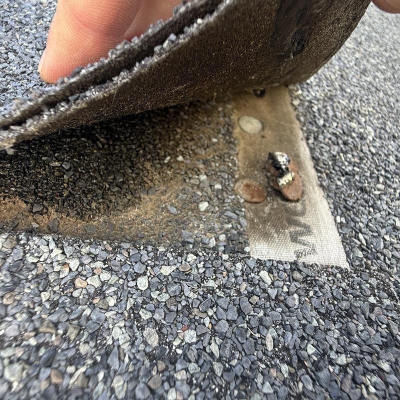 Roofing underlayment with under driven nails exposed Roofing underlayment with under driven nails exposed