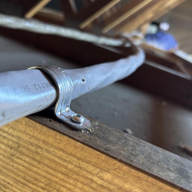 Electrical conduit secured to wood framing in attic space Electrical conduit secured to wood framing in attic space