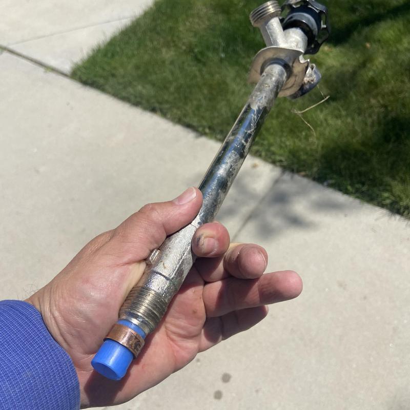 Outdoor hose faucet supply pipe with valve held in hand Outdoor hose faucet supply pipe with valve held in hand