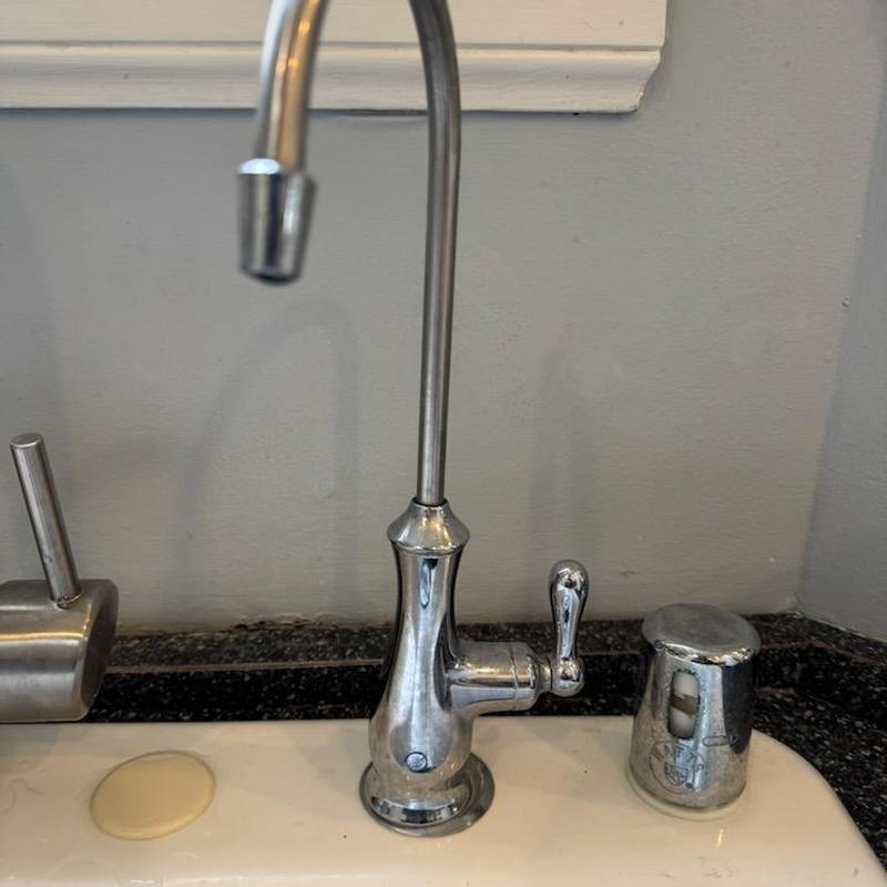 Dispenser faucet installed on kitchen sink countertop