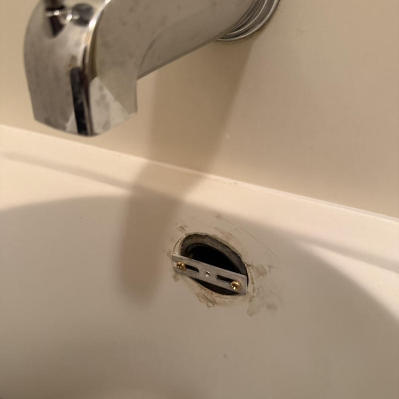 Bathroom sink overflow drain plate with screws installed