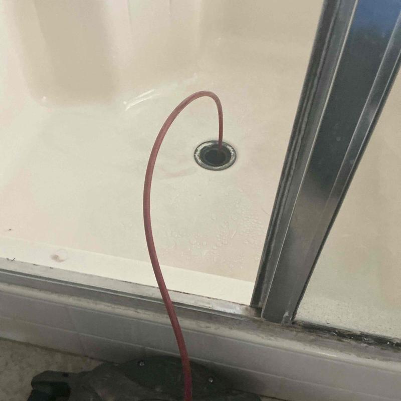 Master shower drain with mechanical snake tool