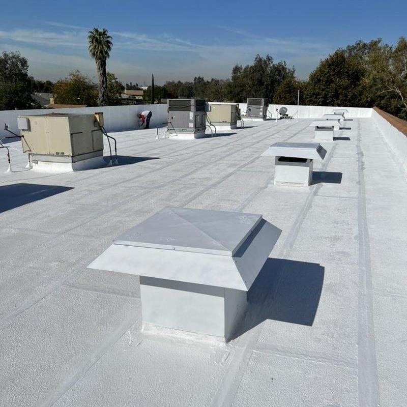 Commercial flat roof with ventilation caps installed Commercial flat roof with ventilation caps installed