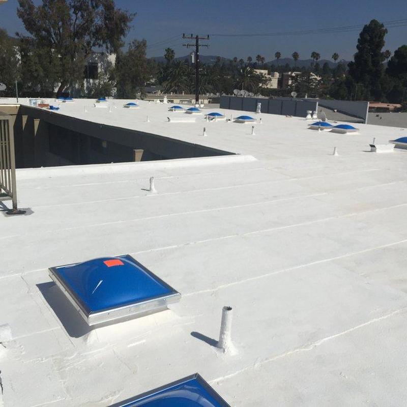 Commercial flat roof with blue dome skylights Commercial flat roof with blue dome skylights