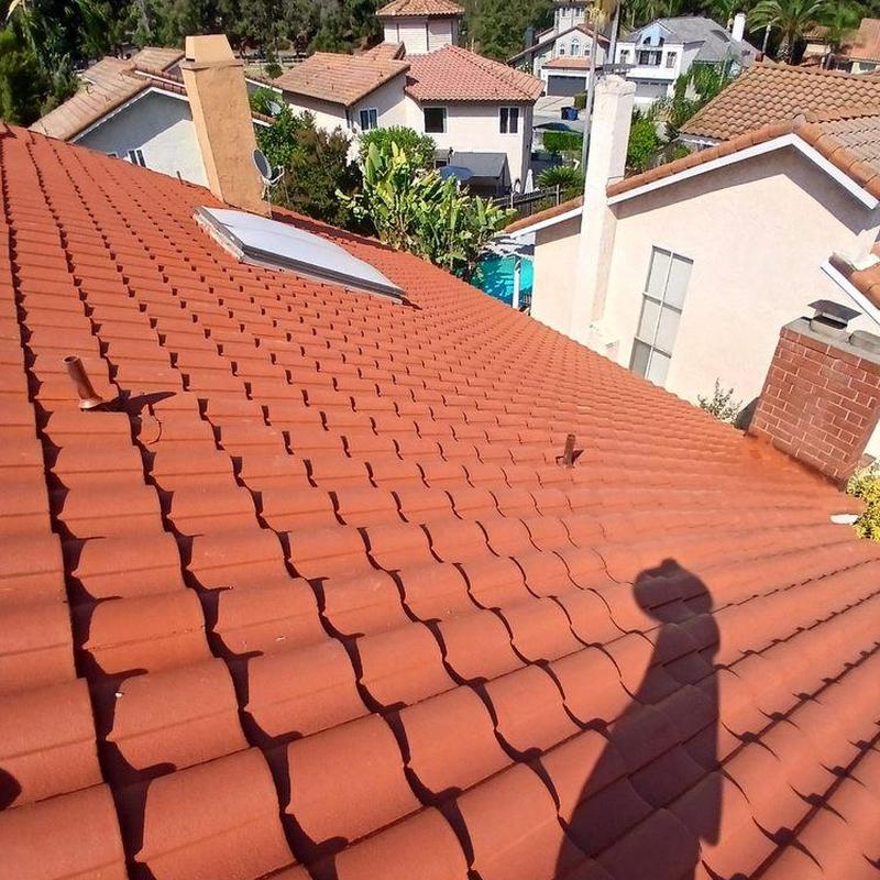 Tile roof with skylight and chimney vents Tile roof with skylight and chimney vents