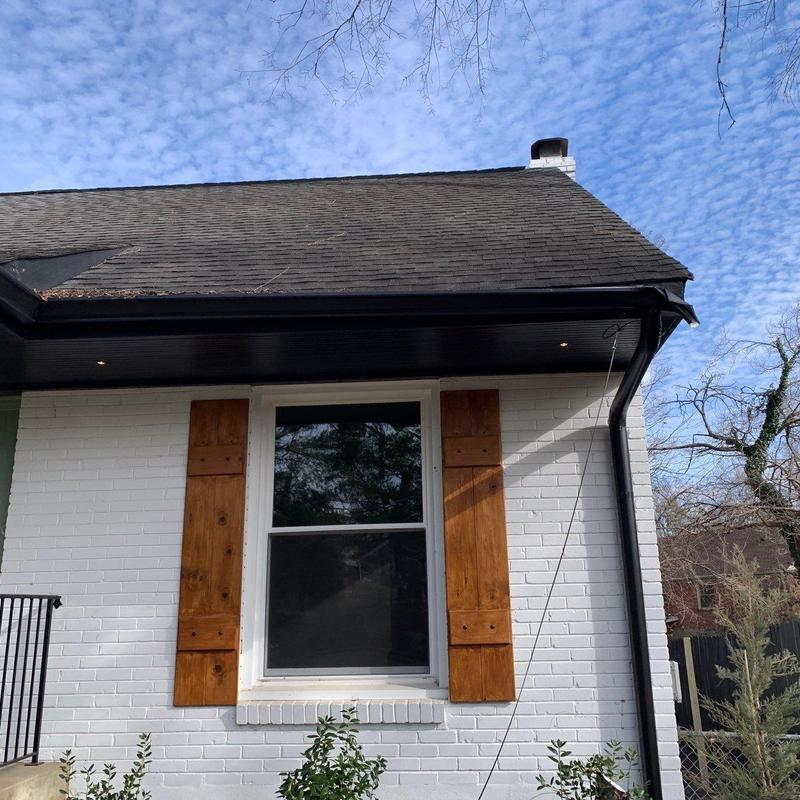 Asphalt shingle roof with slight hail damage above window