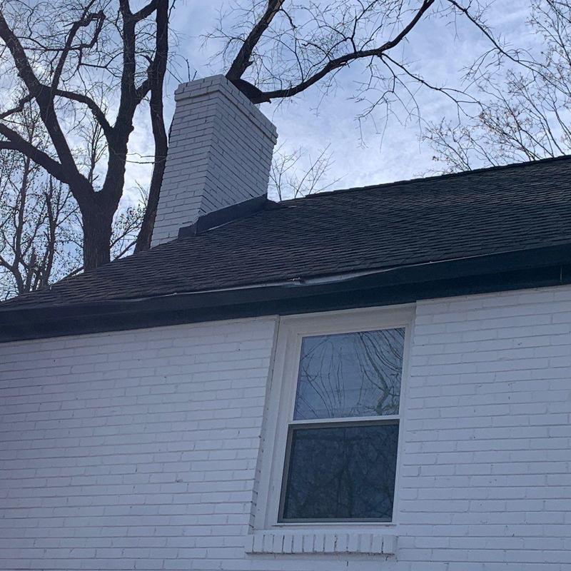 Asphalt shingle roof with chimney and gutters