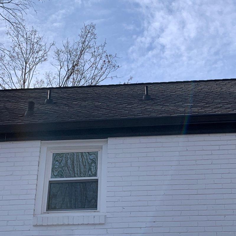 Asphalt shingle roof with vent pipes and weathered areas