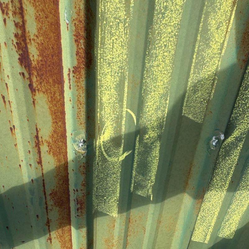 Metal roofing panel damage with chalk markings