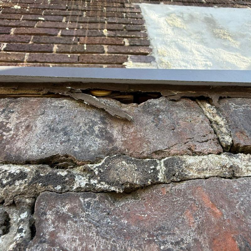 Brick wall mortar joint deterioration with loose material