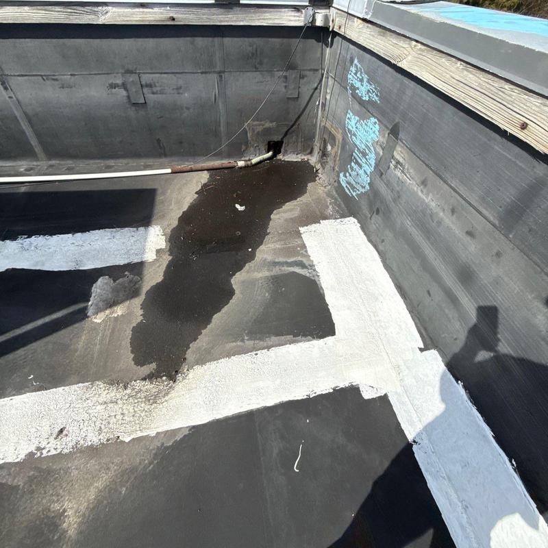 Commercial roof membrane showing hail and water damage