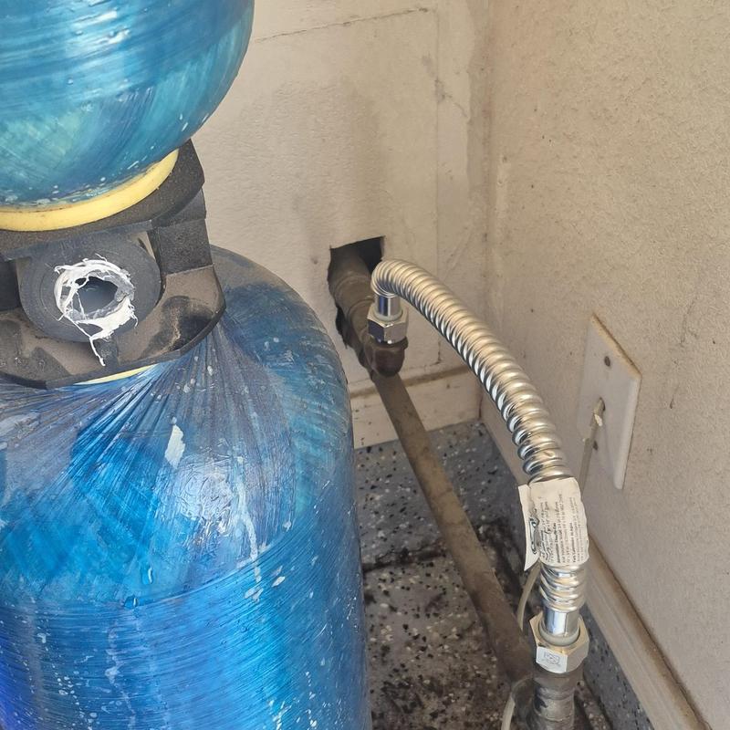 Bypass filter system with flexible metal hose in garage